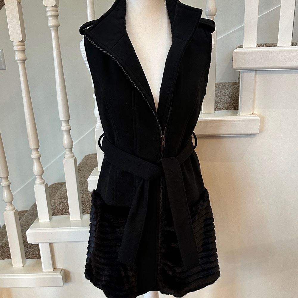 Faux fur vest with button shoulders.